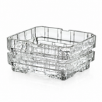 Stacked clear square shallow dishes with patterned sides, viewed at an angle