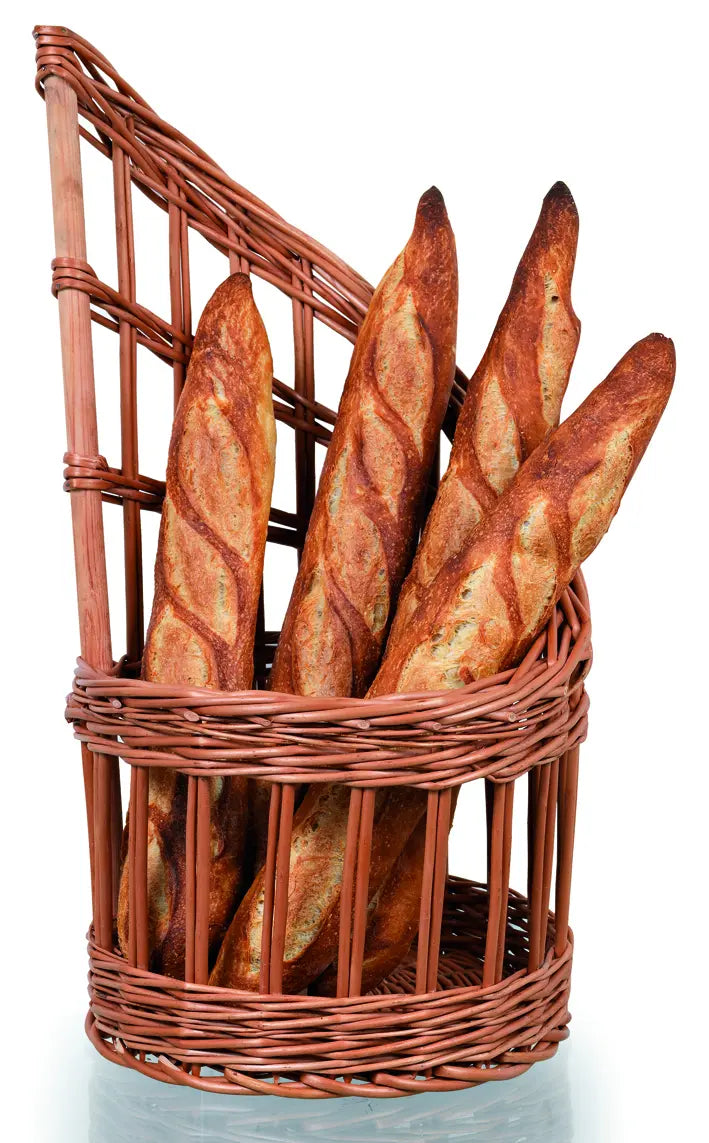Wicker bread basket with raised back holding tall loaves of bread