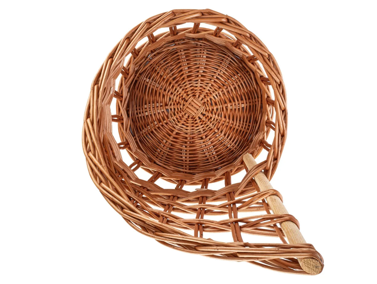 Brown woven basket viewed from above, showing a round base and raised back panel