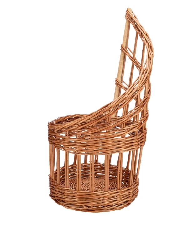 Side view of a brown woven basket with a round base and tall curved back panel
