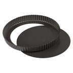 Dark round quiche pan with fluted sides, shown with its removable base separated