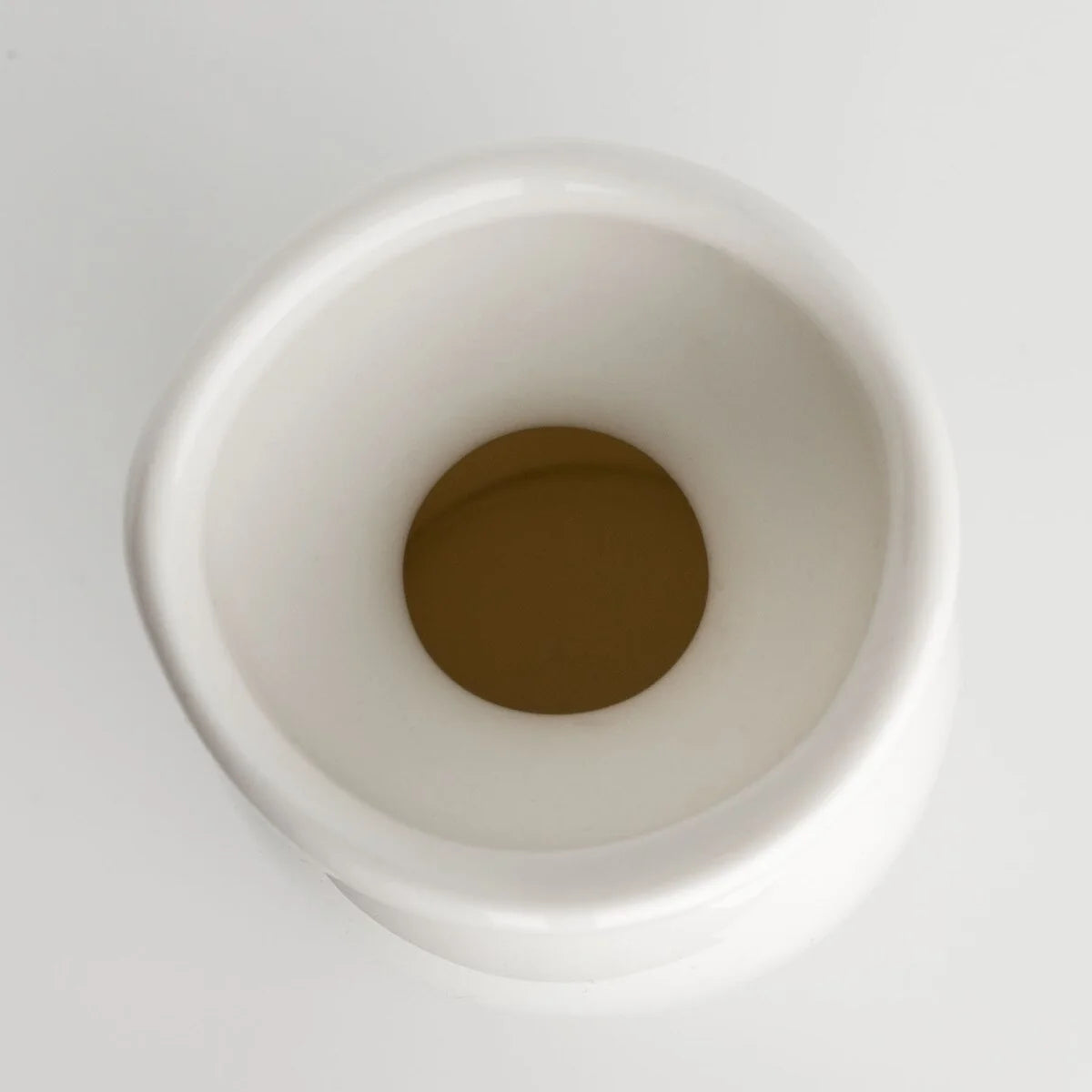 Top view of a white sake bottle showing its round opening and rim