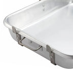 Close-up of a silver-colored rectangular roasting pan showing its side handle, rivets and rolled rim
