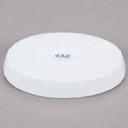 Underside of a white oval dish with a blue maker's mark