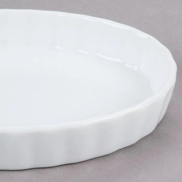 Close-up of a white oval dish showing the rim and fluted outer side